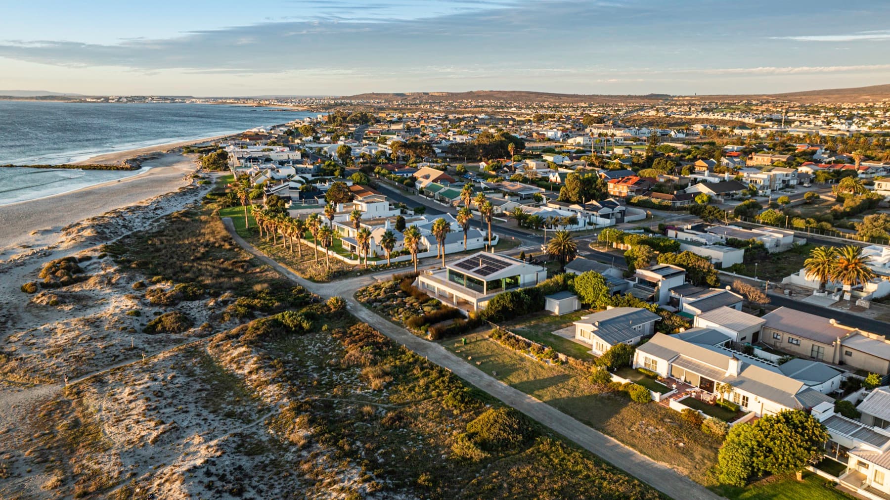 Beachfront homes along the Langebaan shoreline at golden hour