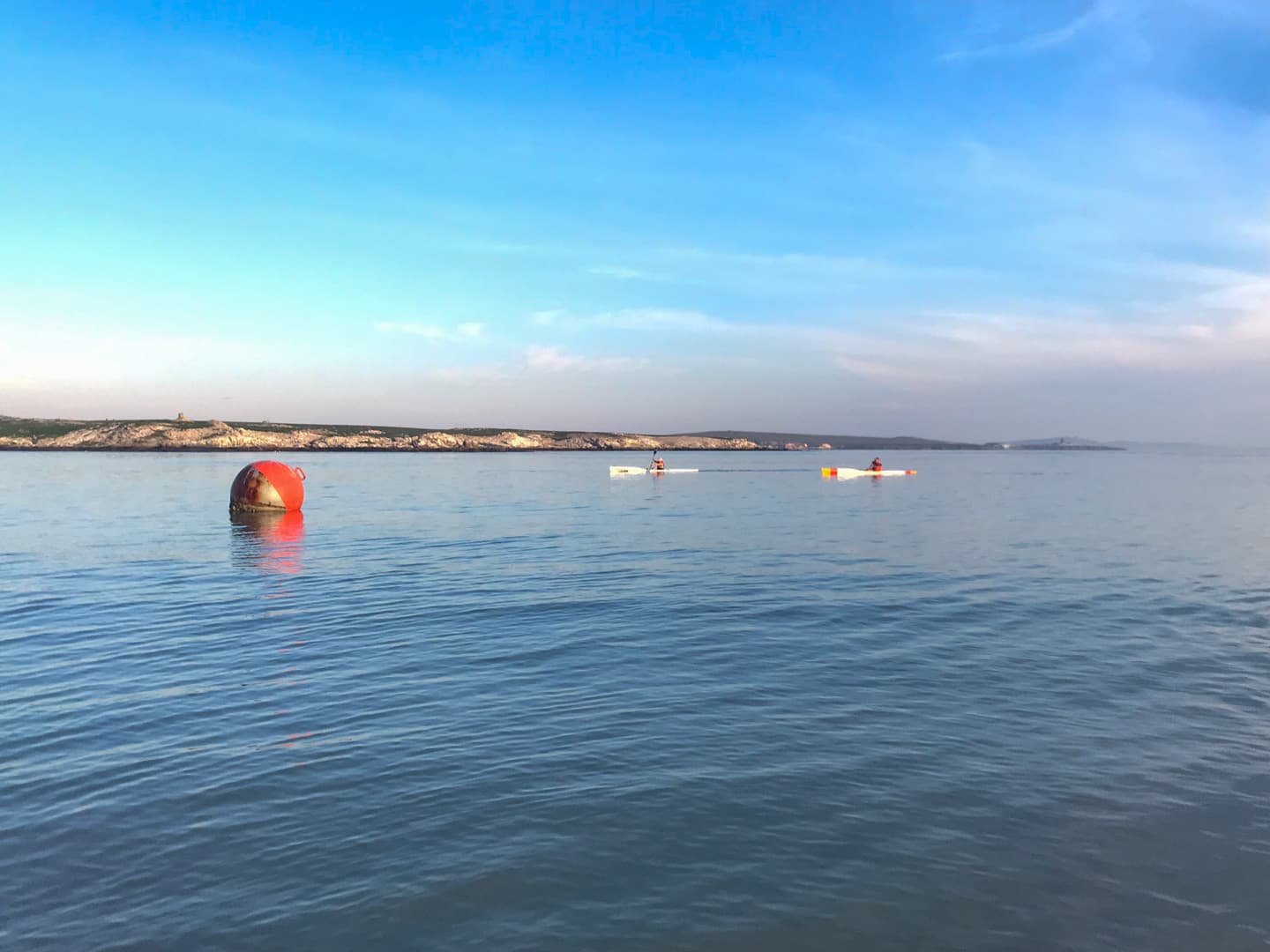 Kayakers on the calm waters of Langebaan Lagoon at sunrise