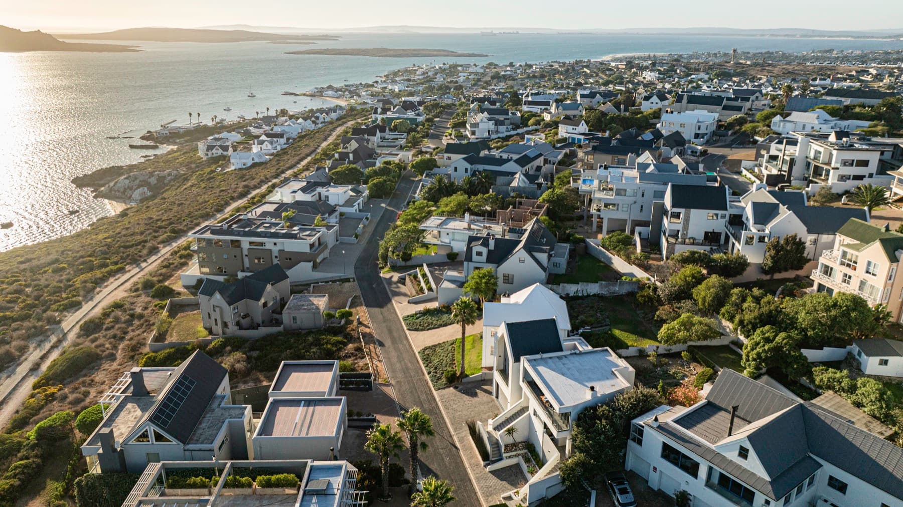 Drone view over Langebaan rooftops and the lagoon at sunset