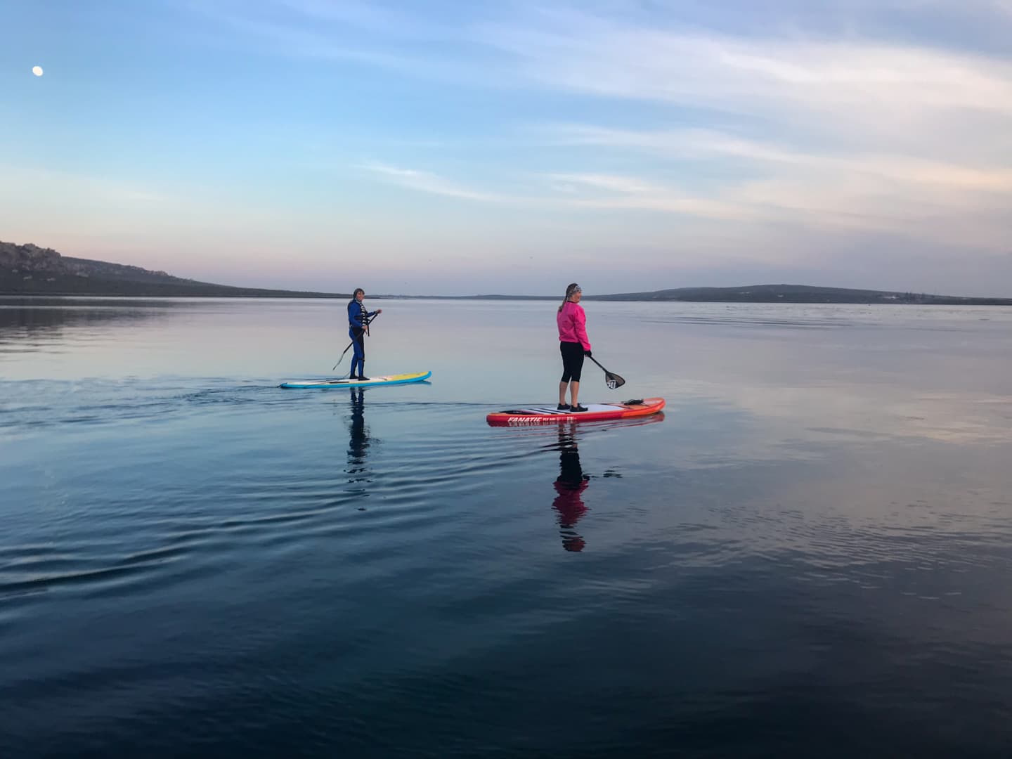 Stand-up paddleboarding on Langebaan Lagoon at dawn